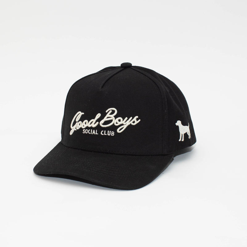 Angled view of the Black Label black hat with cream Good Boys Social Club embroidery and a dog silhouette on the side.