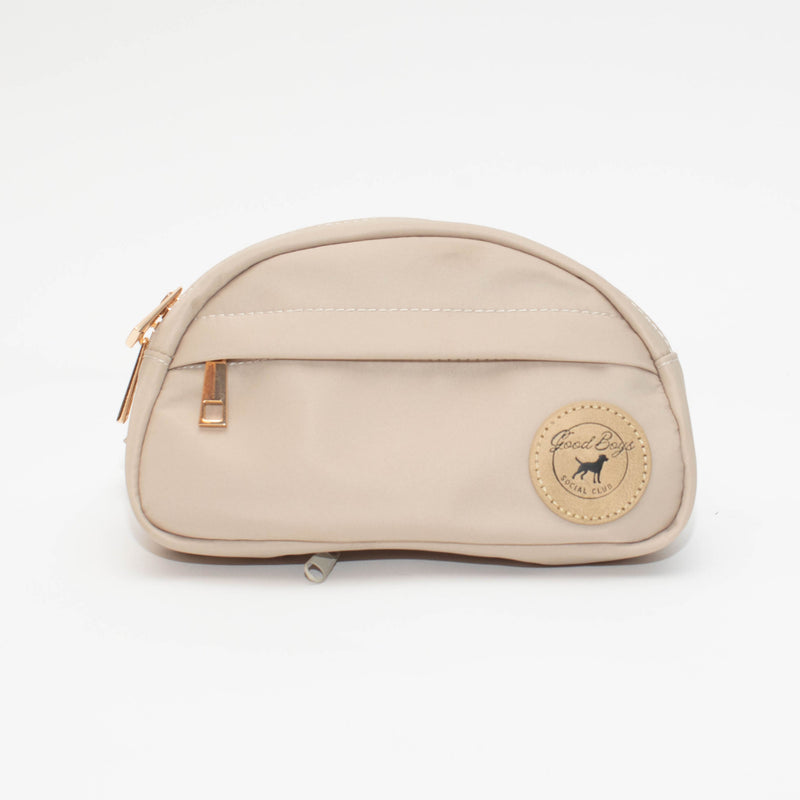 Front view of the beige Good Boys Go Bag with a zippered front pocket and round Good Boys Social Club logo patch.