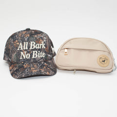The Kit featuring an All Bark No Bite camo hat beside a beige Good Boys Go Bag with a round logo patch.