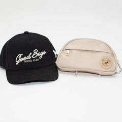 The Kit featuring a black Black Label Good Boys Social Club hat beside a beige Go Bag with a round logo patch.