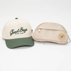 The Kit featuring a cream and Hunter Green Good Boys Social Club hat beside a beige Go Bag with a round logo patch.